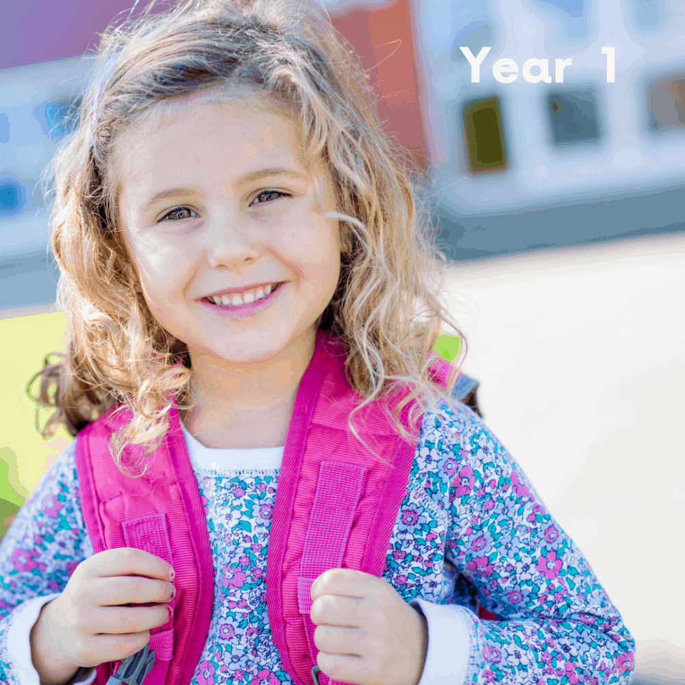 girl's first day of school with a pink school bag